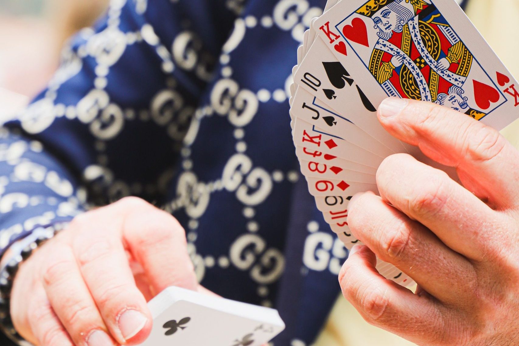 Hands fanning a deck of playing cards