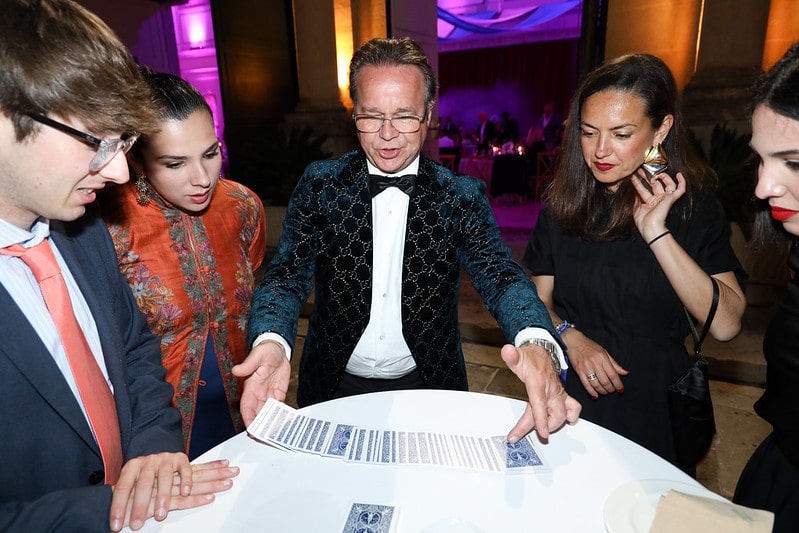 The Millionaire Magician performing for seated wedding guests